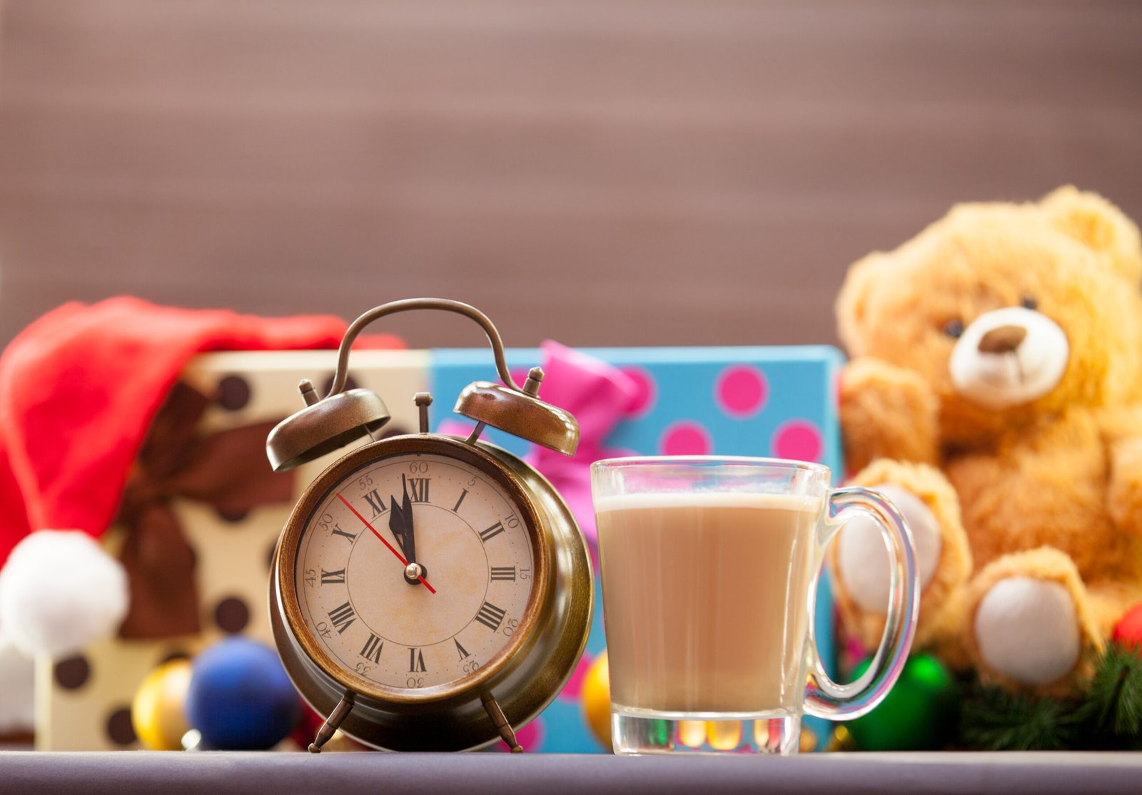 alarm clock with a cup of chocolate liqueur alarm clock with a cup of chocolate liqueur and toys on the background